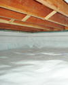 a moisture barrier installed on the walls and floors of a crawl space 
