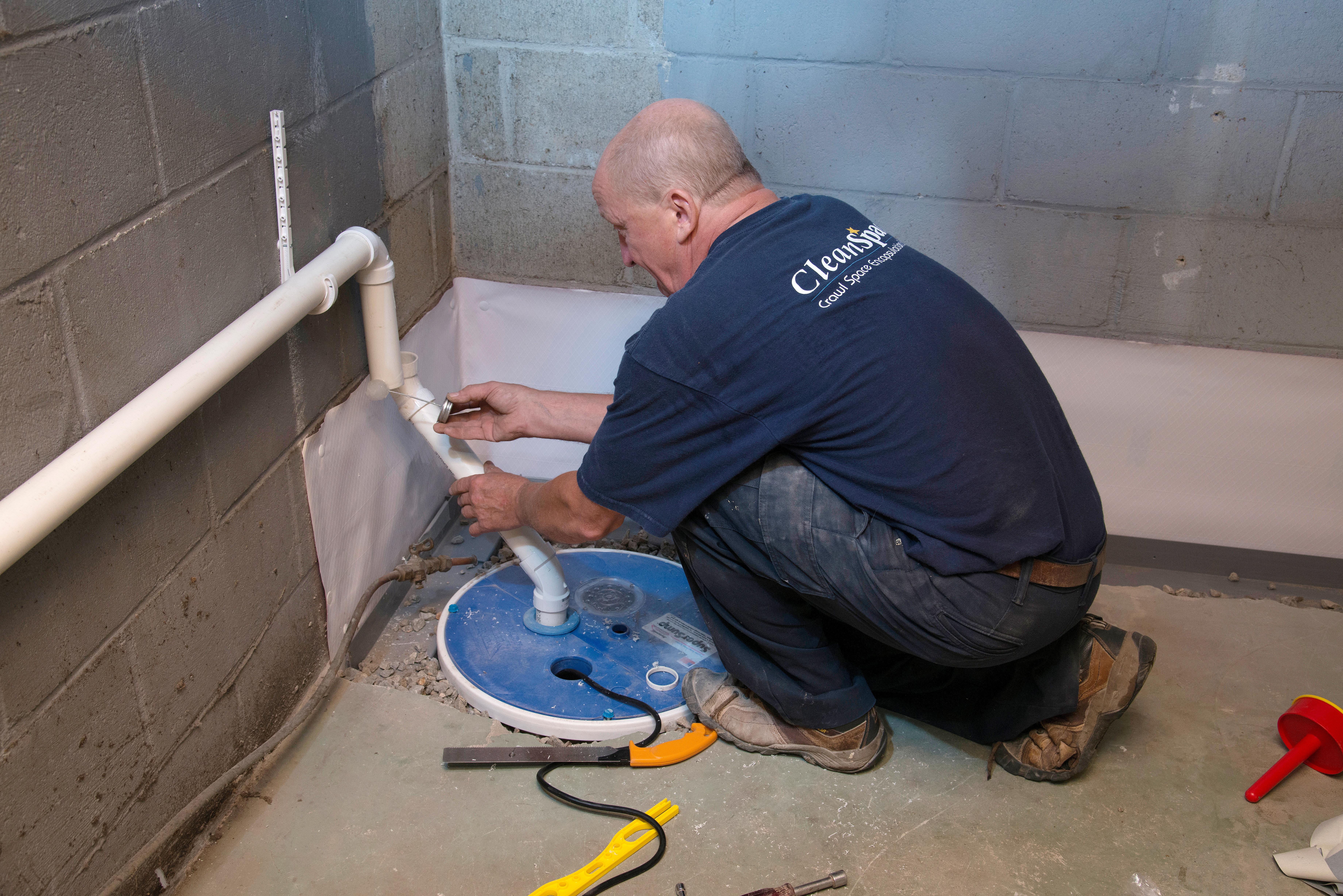 Our crawl space specialist installing a sump pump