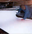 Gunnison insulation being installed in a crawl space.