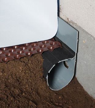 Closeup of a crawl space drainage system installed in Idaho Springs